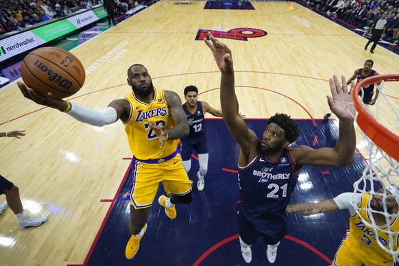Los Angeles Lakers&#039; LeBron James, left, goes up for a shot against Philadelphia 76ers&#039; Joel Embiid during the second half of an NBA basketball game, Monday, Nov. 27, 2023, in Philadelphia. ( ...