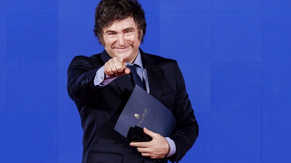 Argentina&#039;s President Javier Milei waves during Atreju 2024, event organized by the Fratelli d&#039;Italia party at the Circo Massimo, Rome, Saturday, Dec 14, 2024 (Roberto Monaldo/LaPresse via A ...