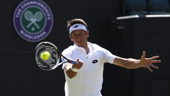 Ukraine&#039;s Sergiy Stakhovsky returns to Japan&#039;s Kei Nishikori during their Men&#039;s Singles Match on day three at the Wimbledon Tennis Championships in London Wednesday, July 5, 2017. (AP P ...