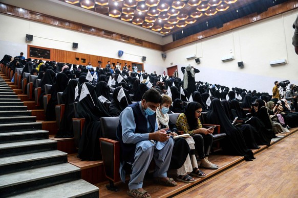 epa09460816 Afghan students listen to women speakers prior to their pro-Taliban rally outside the Shaheed Rabbani Education University in Kabul, Afghanistan, 11 September 2021. The United States envoy ...