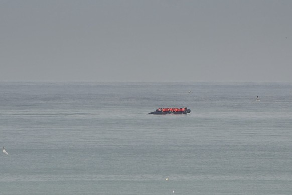 FILE- A boat thought to be with migrants is seen in the sea near the Wimereux beach, France, on Sept. 4, 2024. (AP Photo/Nicolas Garriga, File)