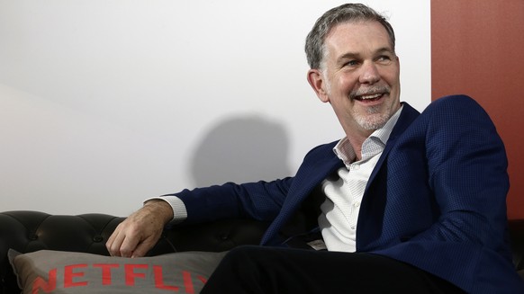 FILE - In this February 28, 2017 file photo, Netflix founder and CEO Reed Hastings smiles during an interview in Barcelona, ​​​​​​Spain.  Hastings and his wife, Patty Quillin, donate $120 million to s…