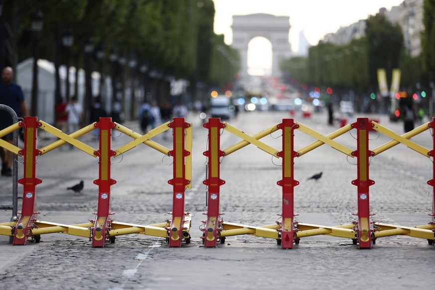 epa10722896 The Arc de Triomphe is seen behind fences amid tight security, after five consecutive nights of riots across the country following the death of Nahel, who was killed by French Police, in P ...