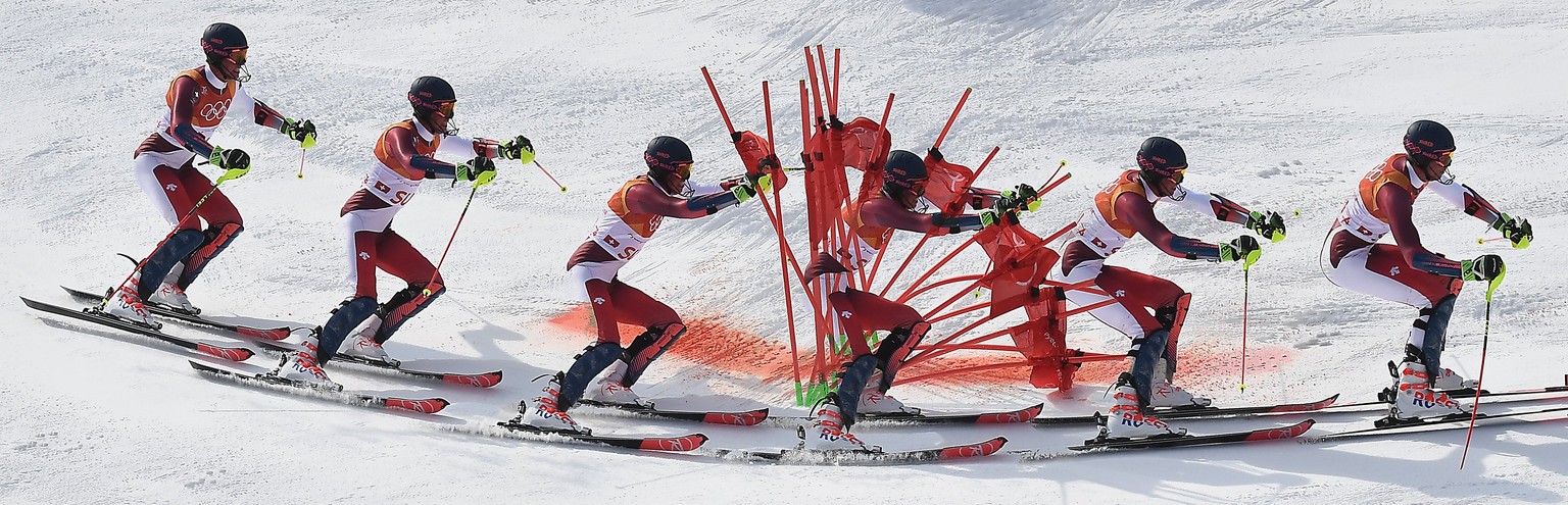 epa06559490 A multiple exposure picture of Michael Matt of Austria (front) and Ramon Zenhaeusern of Switzerland in action during the Alpine Team Event final at the Yongpyong Alpine Centre during the P ...