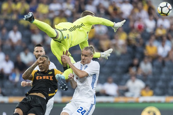 Dynamo Kiev&#039;s goalie Maksym Koval, top, is airborne above YB&#039;s Guillaume Hoarau, left, and Kiev&#039;s Domagoj Vida, during the UEFA Champions League third qualifying round, second leg match ...