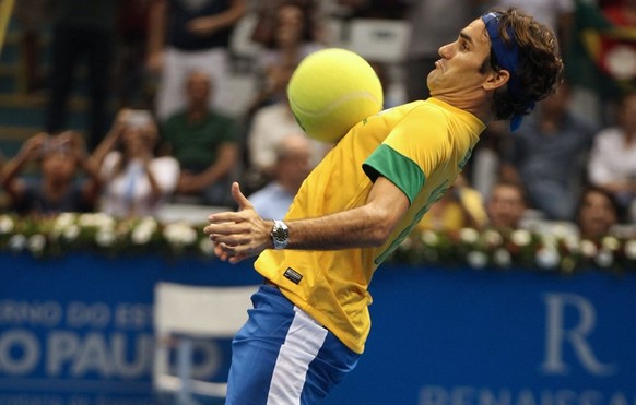 Switzerland&#039;s tennis player Roger Federer, wearing a Brazilian national team soccer jersey, controls a ball during a Gillette Federer Tour exhibition tennis match against Tommy Haas, of Germany,  ...