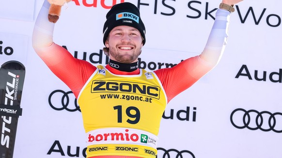 epa11795939 Winner Alexis Monney of Switzerland celebrates on the podium after the Men's Downhill race at the FIS Alpine Skiing World Cup in Bormio, Italy, 28 December 2024. EPA/SOLERO/BISI