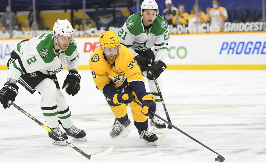 March 30, 2021, Nashville Predators defenseman Roman Josi 59 and Dallas Stars defenseman Jamie Oleksiak 2 fight for the puck during the first period between the Dallas Stars and the Nashville Predator ...