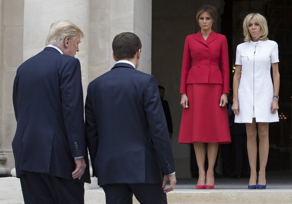 epaselect epa06085482 French First Lady Brigitte Macron (R) and US First Lady Melania Trump (2-R) await French President Emmanuel Macron (C) and US President Donald J. Trump (L) at Les Invalides museu ...