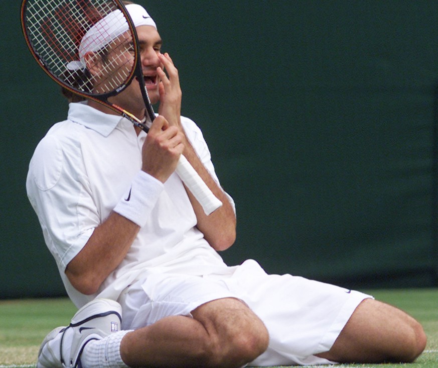 Roger Federer of Switzerland falls to his knees, as he defeats defending champion Pete Sampras in their men&#039;s singles, fourth round match on the Centre Court at Wimbledon, Monday July 2, 2001. (K ...