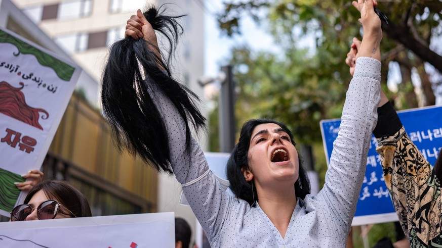 Demonstrators Protest Against Death Of Mahsa Amini In South Korea A member of the Iranian community in Seoul shout slogans after cuts her hair outside the Embassy of the Islamic Republic of Iran durin ...
