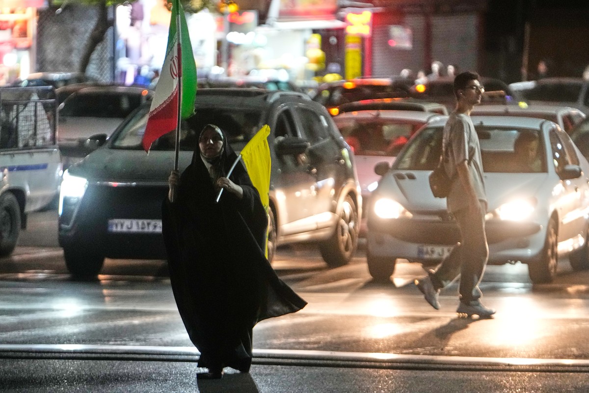 A woman carries an Iranian flag and a flag of Lebanon's militant Hezbollah group while walking towards a pro-government gathering in Tehran, Iran, Sunday, June 7, 2026. (AP Photo/Vahid Salemi)
Ir ...