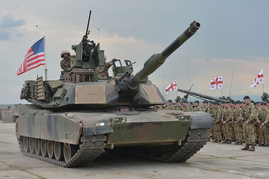 Members of the British Units watch passing US tank Abrams during the opening ceremony of the Exercise Noble Partner 16, a Georgian, British and U.S. military training exercise taking place at Vaziani  ...