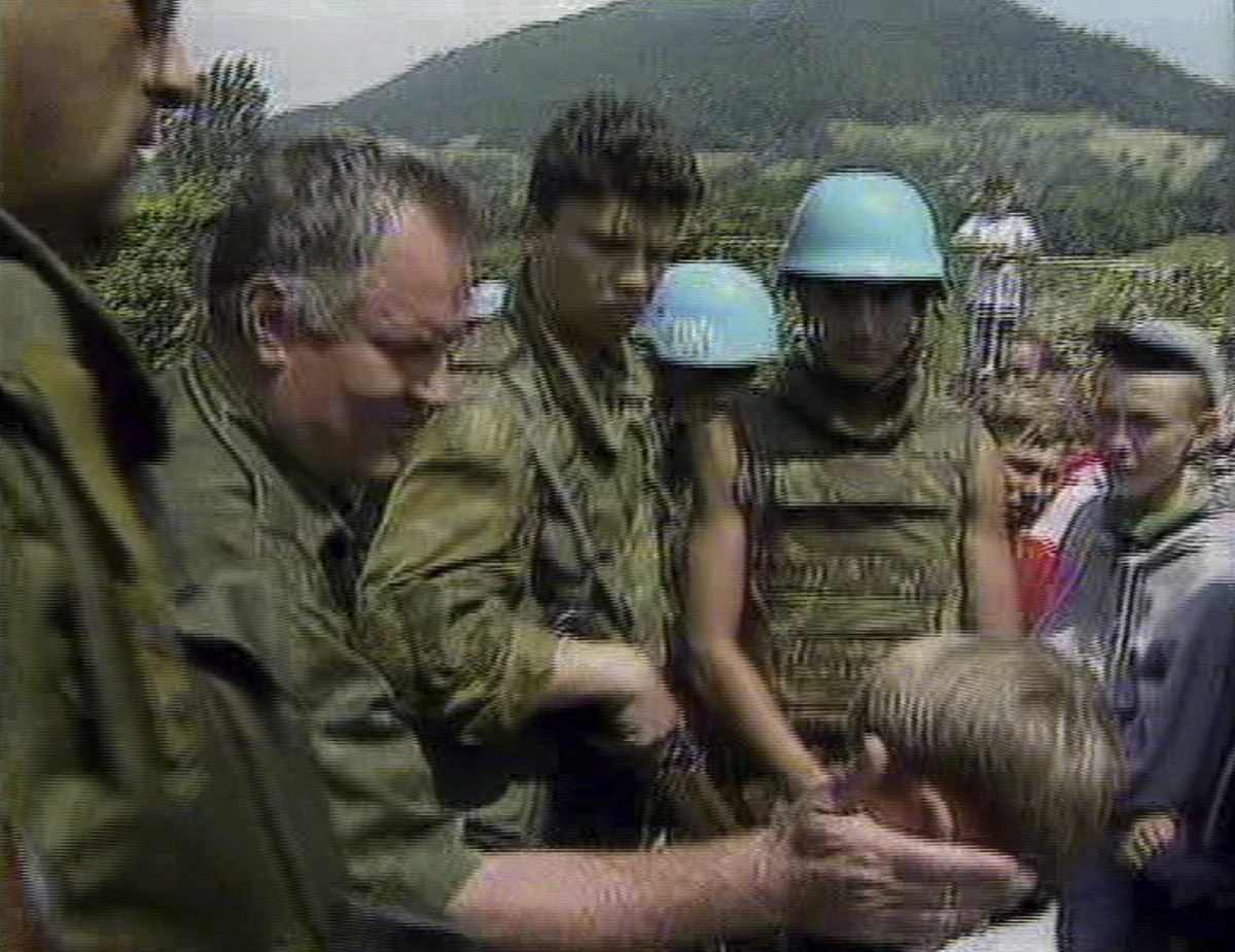 TV FILE IMAGE - In this file image of July 12, 1995 taken from television Bosnian Serb General Ratko Mladic pats a young Muslim boy on the head as he assures residents of Srebrenica they would be safe ...