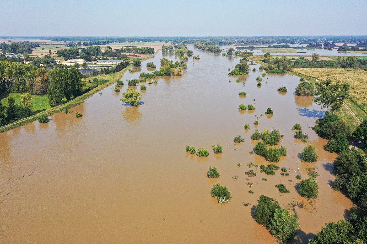 epa11612037 An aerial view taken with a drone shows flood water from the Oder river flowing through Olawa, Lower Silesian Voivodeship, southwestern Poland, 18 September 2024. Emergency services, inclu ...