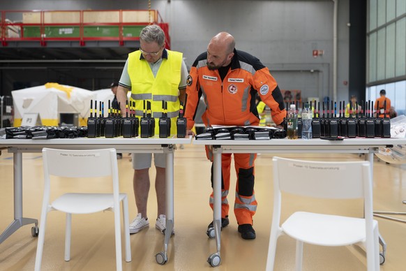 epa13064663 Members of the Swiss Rescue squad check communication devices prior the departure at the Zurich Airport in Kloten, Switzerland, 25 June 2026. The Rescue Squad, with 80 members, eight searc ...