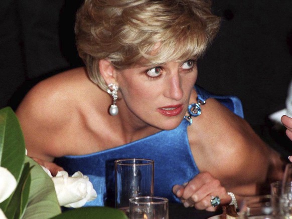 In this Oct. 31, 1996 file photo, Diana, Princess of Wales, attends the Victor Chang charity dinner in Sydney, Australia, wearing an emerald cut aquamarine ring which Meghan Markle was wearing when sh ...