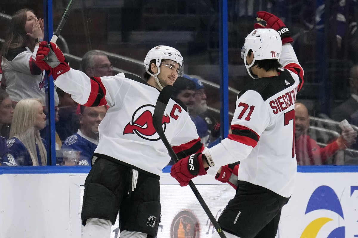 New Jersey Devils center Nico Hischier celebrates his goal against the Tampa Bay Lightning with defenseman Jonas Siegenthaler (71) during the.second period of an NHL hockey game Sunday, March 19, 2023 ...