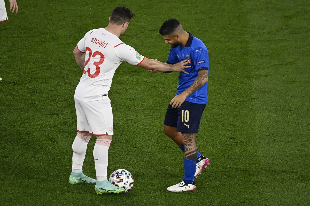 Switzerland's Xherdan Shaqiri, left, touches Italy's Lorenzo Insigne during the Euro 2020 soccer championship group A match between Italy and Switzerland at the Rome Olympic stadium, Wednesd ...