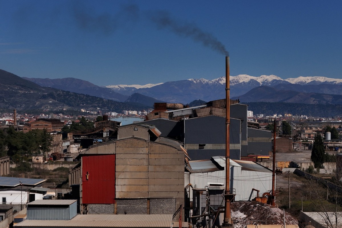 A factory emits black fumes near the former Elbasan metallurgical plant, on March 7, 2025. For several days this summer the Albanian city of Elbasan choked in a dense cloud of stinging smoke coming fr ...