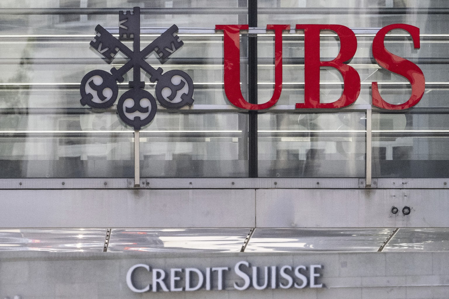 FILE - The logos of the Swiss banks Credit Suisse and UBS are pictured in Zurich, Switzerland, June 12, 2023. In an announcement made on Monday, Aug. 14, 2023, UBS will pay U.S. authorities $1.44 bill ...