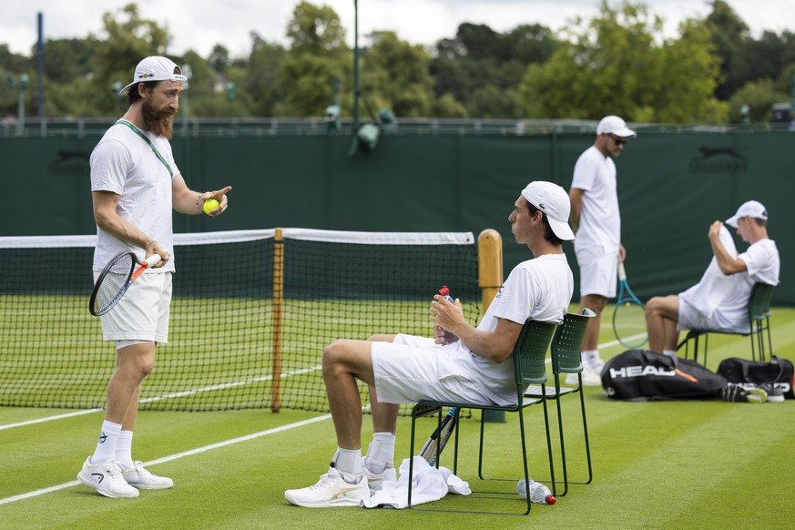 Switzerland&#039;s Marc-Andrea Huesler, right, talks to coach Thiemo Marin Scharfenberger, left, during a training session at the All England Lawn Tennis Championships in Wimbledon, London, Saturday,  ...