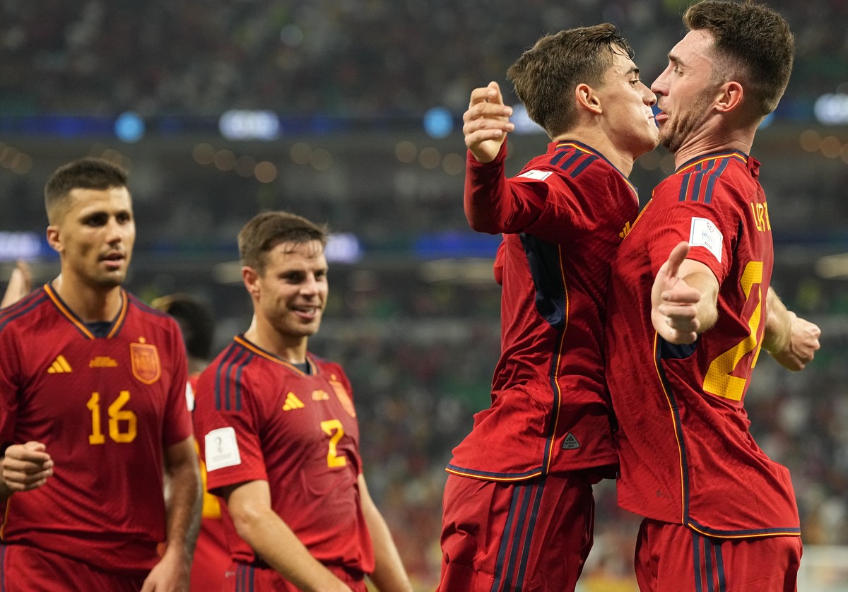 Spain's Gavi, second right, celebrates with Aymeric Laporte after scoring his side's fifth goal during the World Cup group E soccer match between Spain and Costa Rica, at the Al Thumama Stad ...