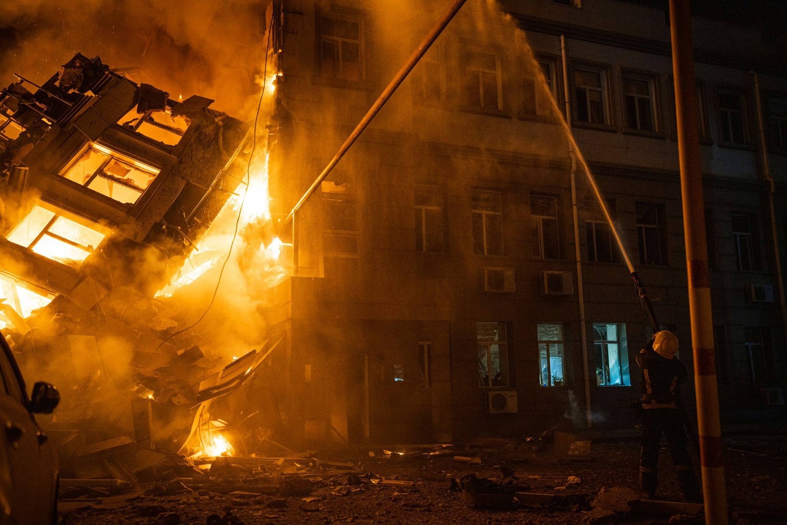 July 20, 2023, Odessa, Odessa, Ukraine: A firefighter works at the site of an administrative building heavily damaged by a Russian missile strike.  Odessa Ukraine - ZUMA 20230720_int_z03_031 Copyright: xS ...