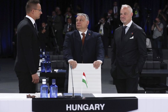 epa10043049 Hungarian Prime Minister Viktor Orban (C) stands next to his Defense Minister Kristof Szalay-Bobrovniczky (R) during the second and last day of the NATO Summit at the IFEMA Convention Cent ...