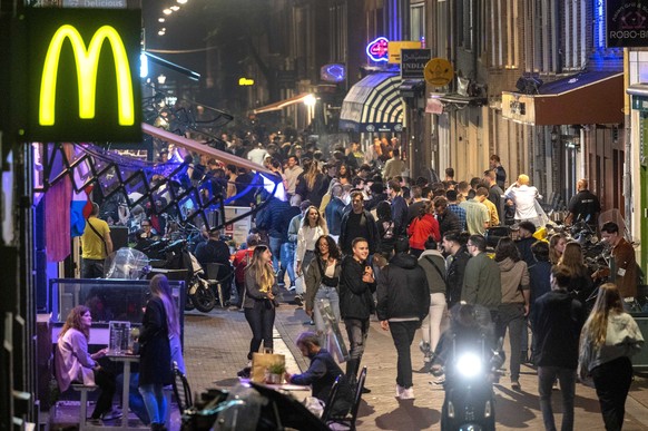 epa09334933 A view of nightlife in Amsterdam, the Netherlands, early 10 July 2021. Due to a surge in the number of COVID-19 infections in the Netherlands, starting from 10 July until 13 August, the go ...