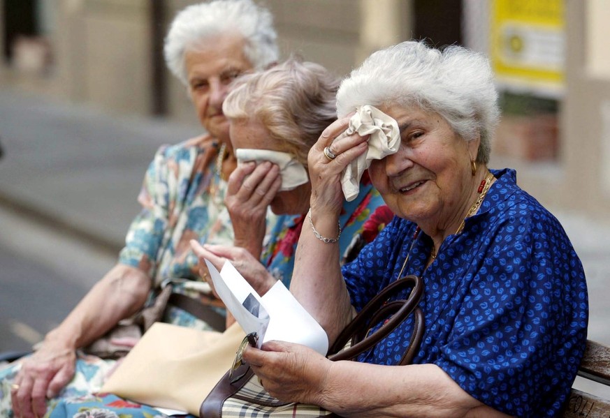 Three elderly ladies in Pontedera, Italy wipe the sweat from their foreheads as temperatures surged all over Italy on Friday, 23 July 2004. Ageing Society launched an appeal for not leave old people a ...