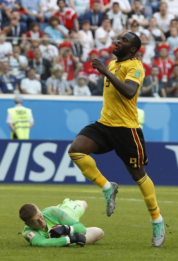 England goalkeeper Jordan Pickford stops a scoring attempt by Belgium&#039;s Romelu Lukaku during the third place match between England and Belgium at the 2018 soccer World Cup in the St. Petersburg S ...