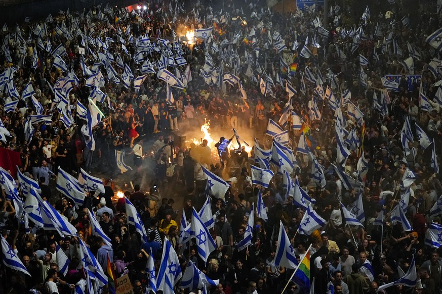 FILE - Israelis opposing Prime Minister Benjamin Netanyahu's judicial overhaul plan set up bonfires and blocked a highway during a protest shortly after the Israeli leader fired his defense ministers...