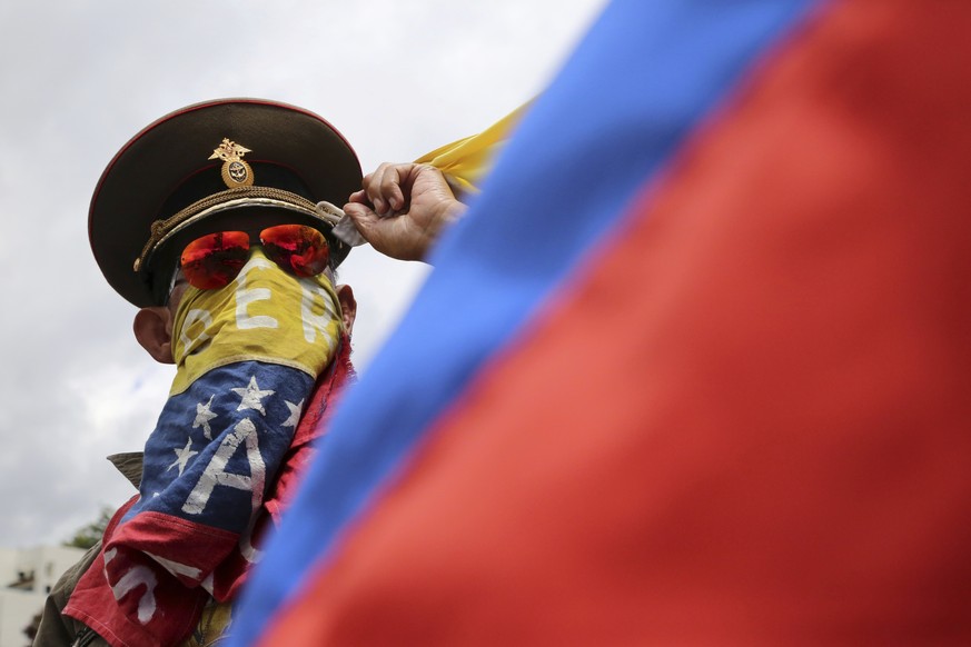 In this Sunday, Aug. 6, 2017 photo, an anti-government demonstrator wearing a Russian military hat protests the government of Venezuela&#039;s President Nicolas Maduro in Caracas, Venezuela. Venezuela ...
