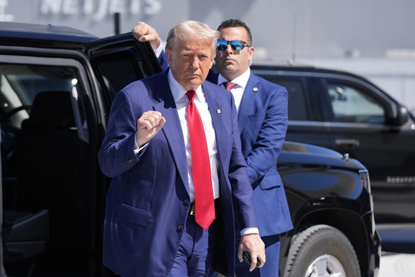 Republican presidential nominee former President Donald Trump gestures as he arrives at Harry Reid International Airport to board a plane after a campaign trip, Saturday, Sept.14, 2024, in Las Vegas.  ...