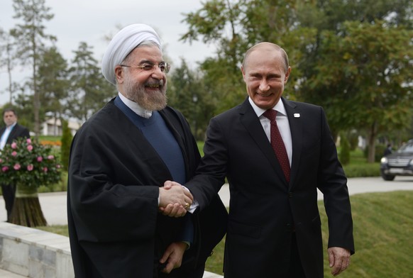 Russian President Vladimir Putin shakes hands with Iranian President Hassan Ruhani, left, prior to the Caspian Summit in Astrakhan, Russia, Monday, Sept. 29, 2014. (AP Photo/RIA Novosti, Alexei Nikols ...