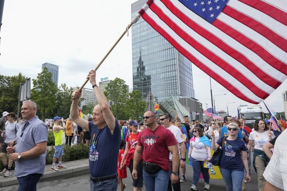 U.S. Ambassador Mark Brzezinski holds a U.S. flag as he marches in the yearly pride parade in Warsaw, Poland, on Saturday, June 17, 2023. The ambassador was sending a clear message of Washington&#039; ...