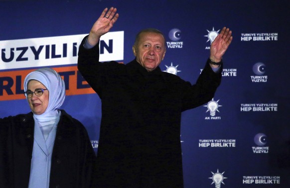 Turkish President Recep Tayyip Erdogan, right, and his wife, Emine, acknowledge supporters at the party headquarters, in Ankara, Turkey, early Monday, May 15, 2023. Erdogan, who has ruled his country  ...