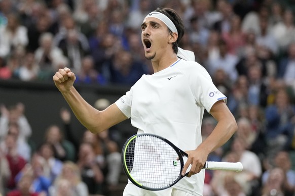 Italy&#039;s Lorenzo Sonego celebrates winning a point against Switzerland&#039;s Roger Federer during the men&#039;s singles fourth round match on day seven of the Wimbledon Tennis Championships in L ...