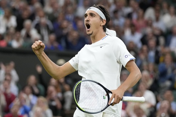 Italy&#039;s Lorenzo Sonego celebrates winning a point against Switzerland&#039;s Roger Federer during the men&#039;s singles fourth round match on day seven of the Wimbledon Tennis Championships in L ...