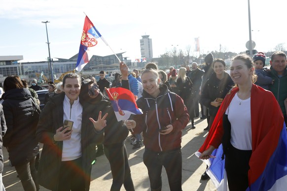 epa09691069 Supporters of Serbian tennis player Novak Djokovic gather at the Nikola Tesla Airport in Belgrade, Serbia, 17 January 2022. Djokovic on 16 January lost his court appeal against deportation ...