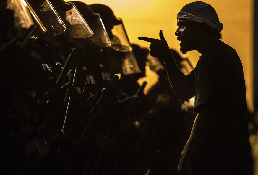 A protester vents at a line of Tucson Police Officers in riot gear at Cushing Street and Church Avenue early on Saturday, May 30, 2020. The protest in Tucson was similar to those in numerous cities ac ...