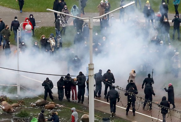 epa08835990 Belarusian policemen detain a protester during a rally against the government and President Lukashenko in Minsk, Belarus, 22 November 2020. Opposition activists continue their protest acti ...