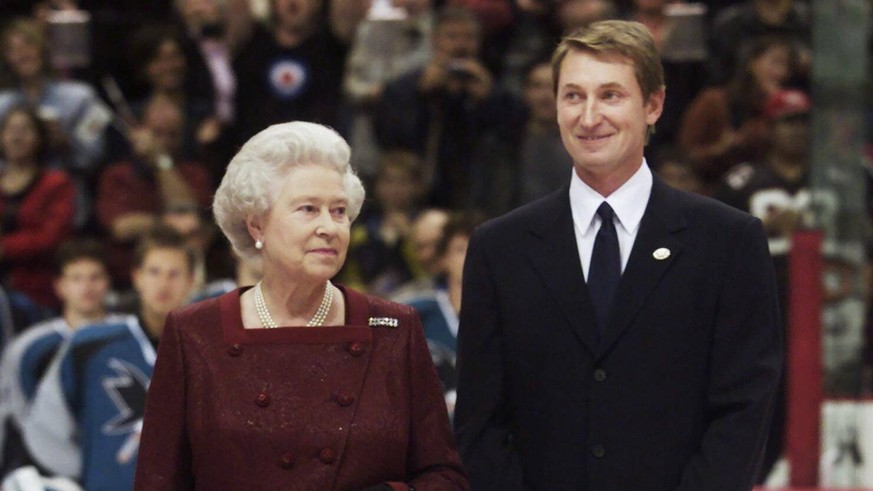 October 6, 2002, VANCOUVER, BC, Canada: Queen Elizabeth II and Wayne Gretzky stand at centre ice during the playing of the anthems at GM Place in Vancouver Sunday Oct. 6, 2002. The Queen dropped the p ...