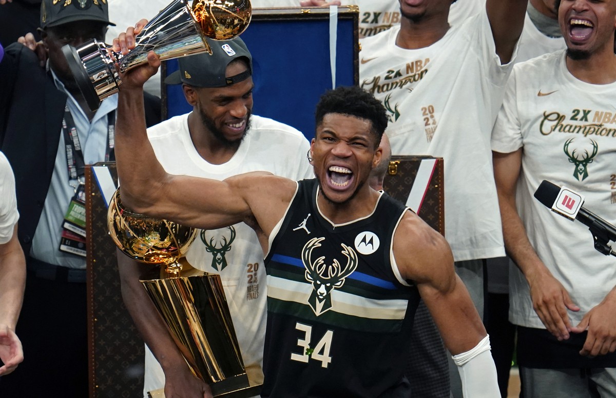 Milwaukee Bucks forward Giannis Antetokounmpo (34) holds with the finals MVP trophy after the Bucks defeated the Phoenix Suns in Game 6 of basketball's NBA Finals in Milwaukee, Tuesday, July 20,  ...
