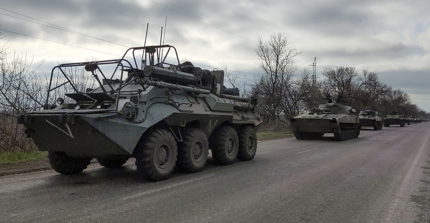 FILE - A Russian military convoy moves on a highway in an area controlled by Russian-backed separatist forces near Mariupol, Ukraine, on April 16, 2022. As the war in Ukraine stretches into its sevent ...