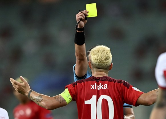 Switzerland&#039;s Granit Xhaka gets shown the yellow card during the Euro 2020 soccer championship group A match between Switzerland and Turkey at the Baku Olympic Stadium in Baku, Azerbaijan, Sunday ...