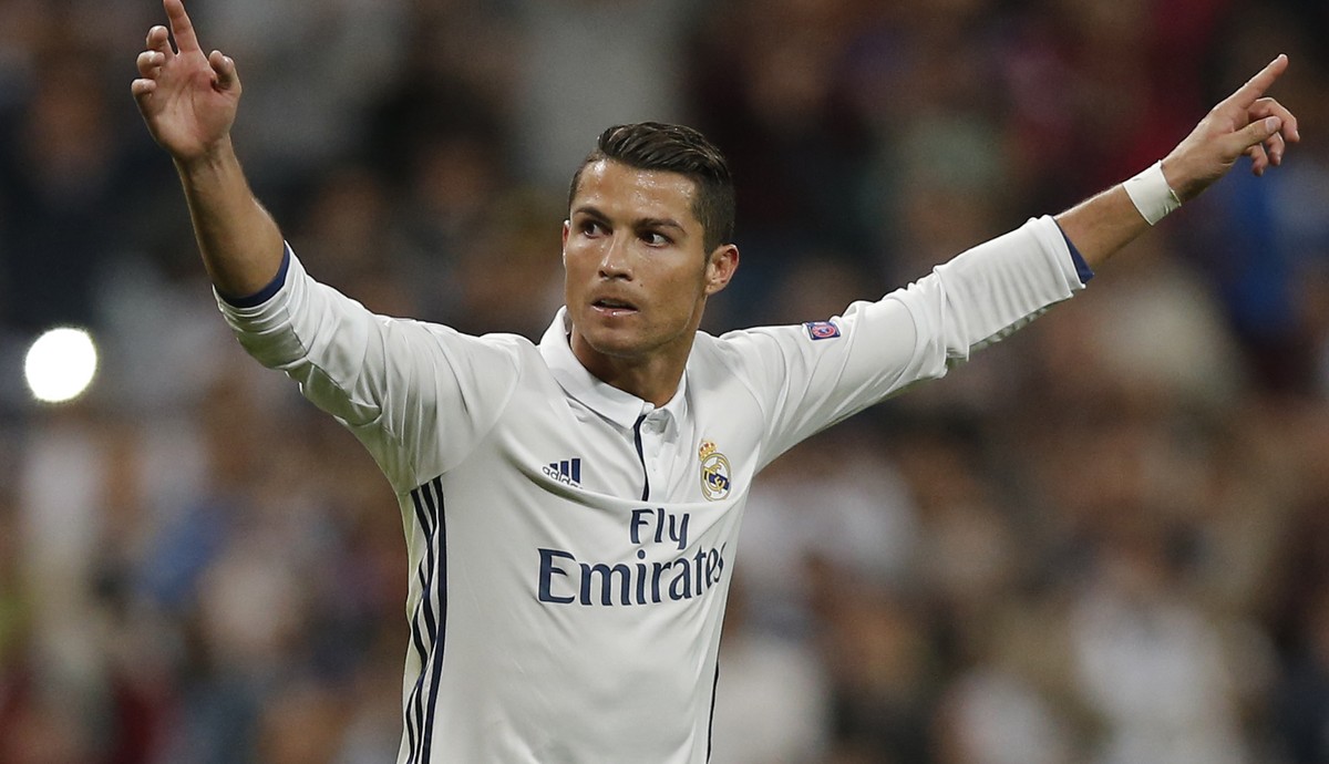 Real Madrid's Cristiano Ronaldo celebrates scoring his side's first goal during a Champions League, Group F soccer match between Real Madrid and Sporting, at the Santiago Bernabeu stadium in ...
