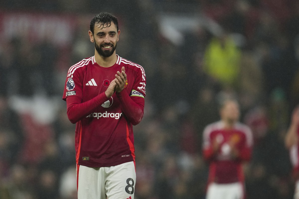 Manchester United's Bruno Fernandes celebrates at the end of the English Premier League soccer match between Manchester United and Leicester City, at the Old Trafford stadium in Manchester, Engla ...
