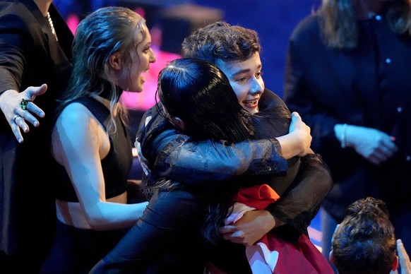 Remo Forrer of Switzerland, center, celebrates qualifying for final at the Eurovision Song Contest in Liverpool, England, Tuesday, May 9, 2023. (AP Photo/Martin Meissner)